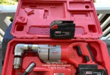 A Milwaukee brand cordless half-inch angle drill inside of a plastic case. There's a spare battery, a battery charger, and a handle for holding the drill steady. This is not normally a DIYer tool unless some serious drilling needs to be done. Image is copyright 2026 John Grabowski, All Rights Reserved.