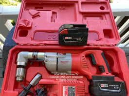 A Milwaukee brand cordless half-inch angle drill inside of a plastic case. There's a spare battery, a battery charger, and a handle for holding the drill steady. This is not normally a DIYer tool unless some serious drilling needs to be done. Image is copyright 2026 John Grabowski, All Rights Reserved.