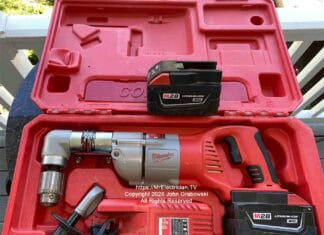 A Milwaukee brand cordless half-inch angle drill inside of a plastic case. There's a spare battery, a battery charger, and a handle for holding the drill steady. This is not normally a DIYer tool unless some serious drilling needs to be done. Image is copyright 2026 John Grabowski, All Rights Reserved.